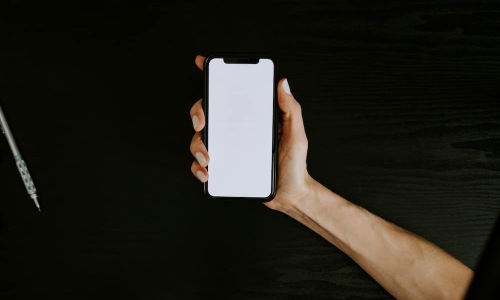 a hand holding a smart phone