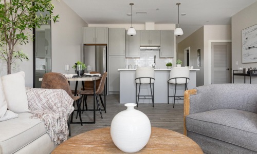 a living room with a table and chairs